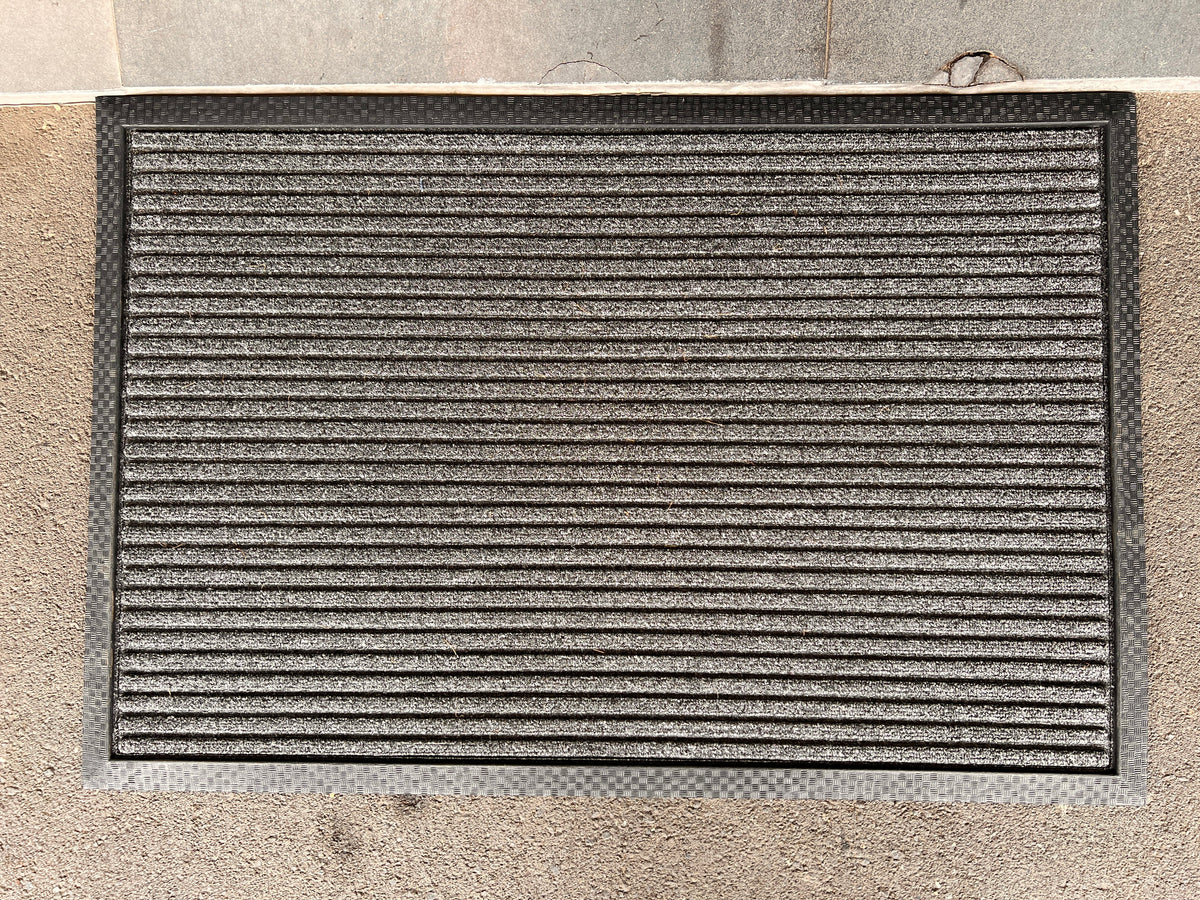 Coir and rubber doormat with "Welcome" design from India, ideal for outdoor entryways at your doorstep.