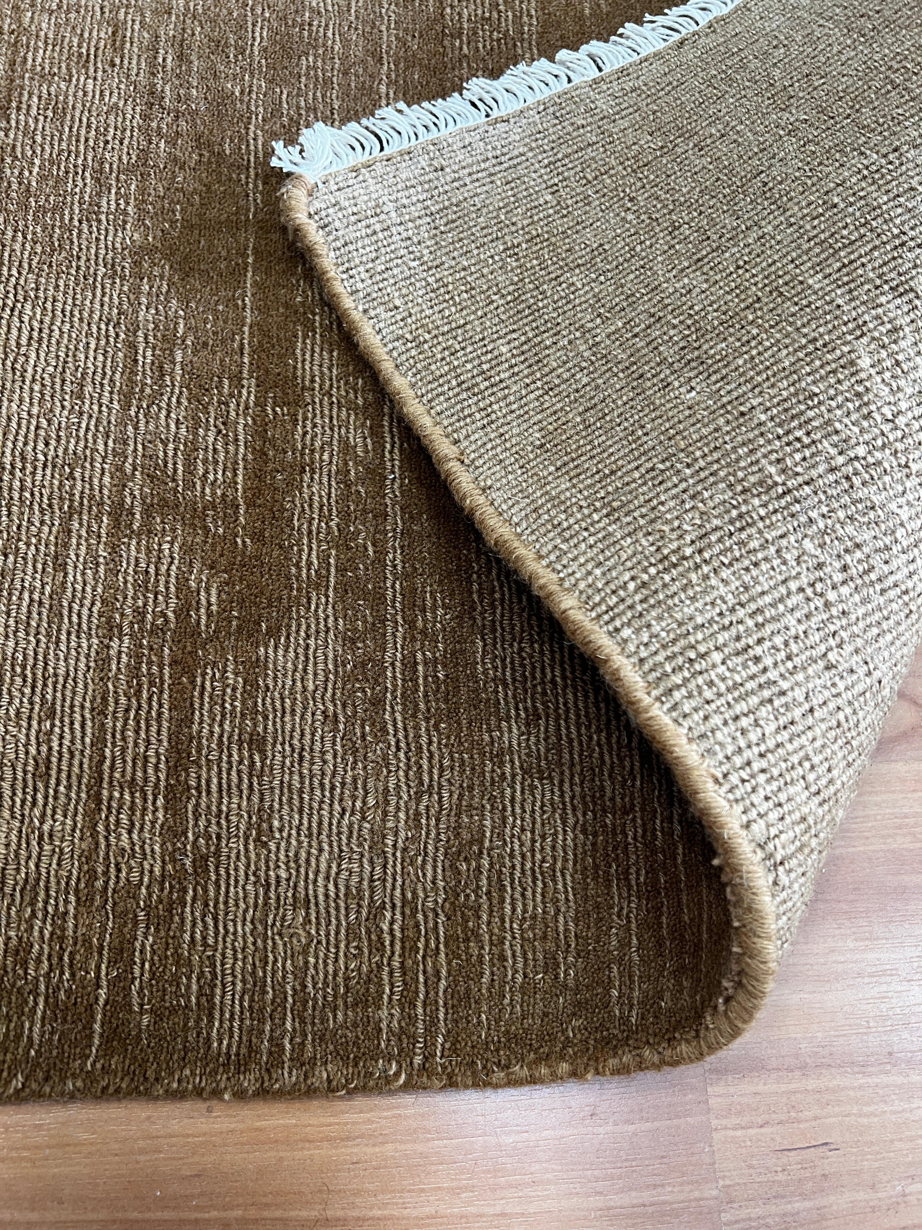 India Hudson Almond pure wool fabric close-up showing soft, textured almond-colored wool fibers.