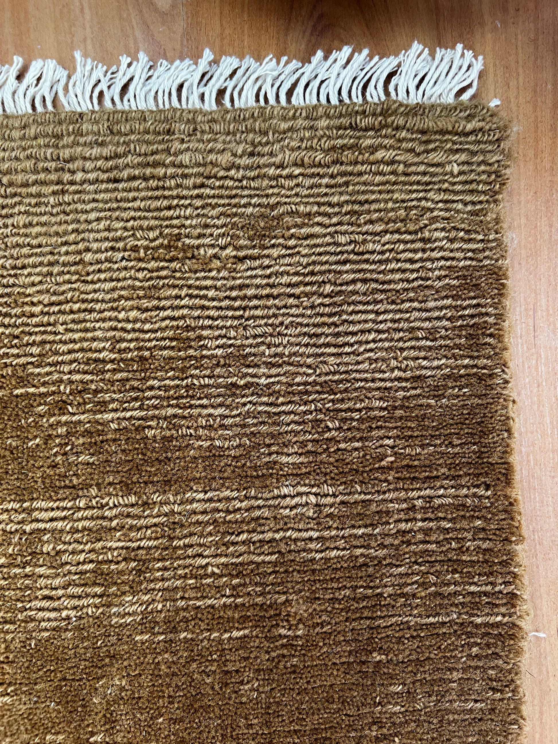 India Hudson Almond pure wool fabric, close-up view showing soft texture and natural almond color fibers.