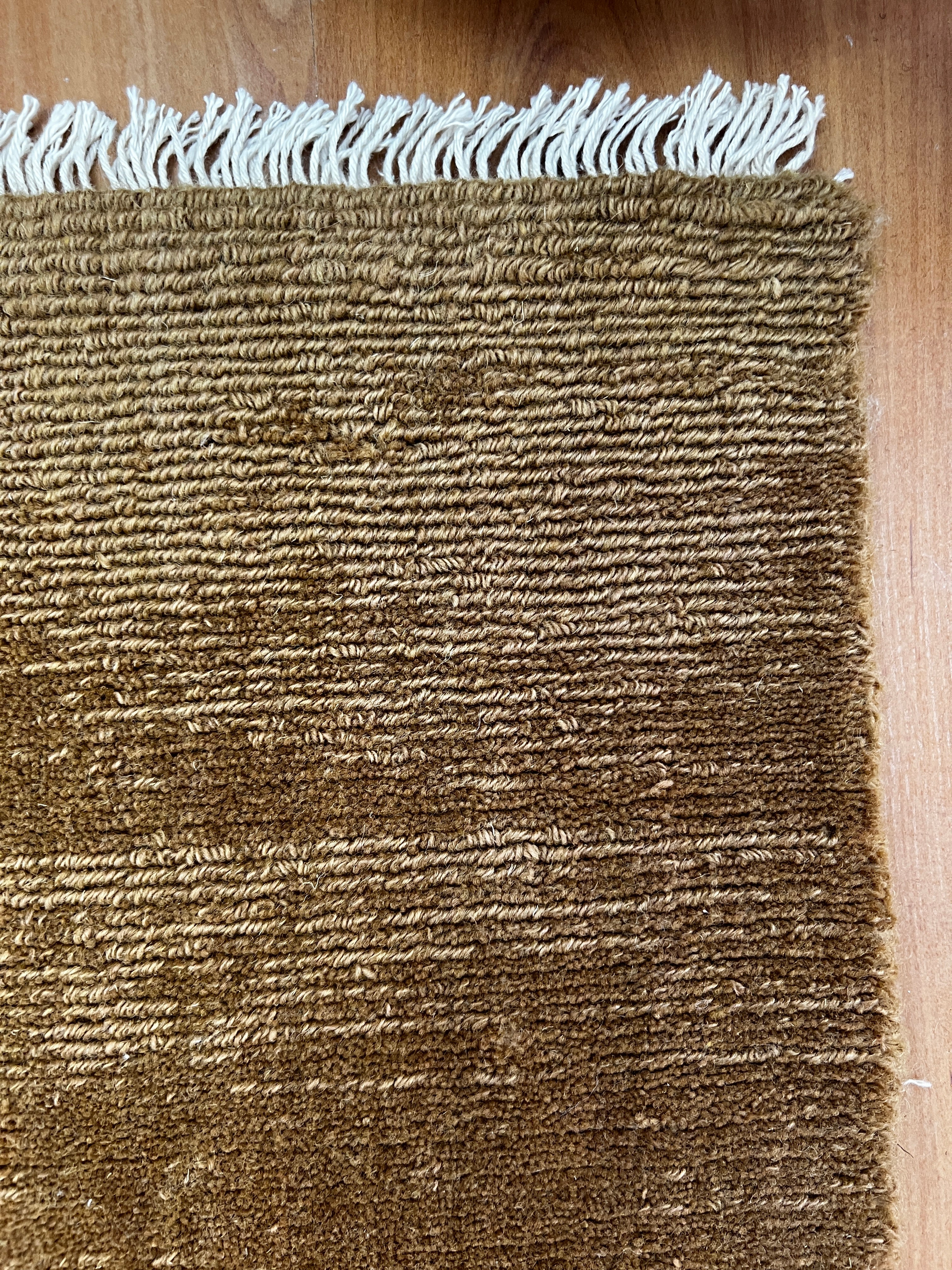India Hudson Almond pure wool fabric, close-up view showing soft texture and natural almond color fibers.