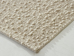 Soft Itsy Bitsy oatmeal-colored plush made from polyester, wool, and cotton by India, shown in a close-up image.
