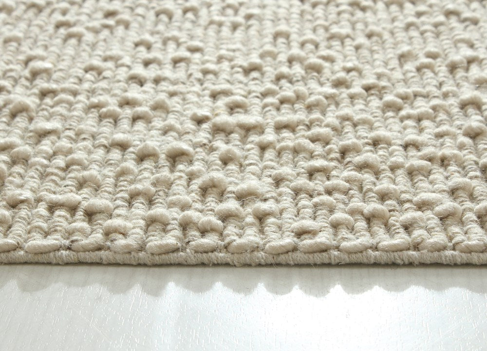 Close-up of Itsy Bitsy oatmeal-colored polyester wool and cotton fabric by India, showing soft texture and woven details.