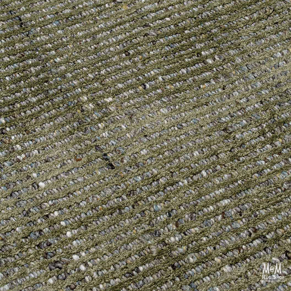 India Garcia Olive wool and viscose rug displaying a green and beige patterned design on a textured surface.