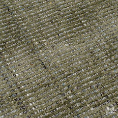India Garcia Olive wool and viscose rug displaying a green and beige patterned design on a textured surface.