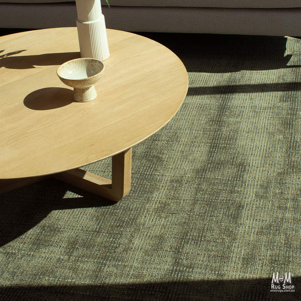 India Garcia Olive wool and viscose rug with a textured, patterned design featuring green and neutral tones.