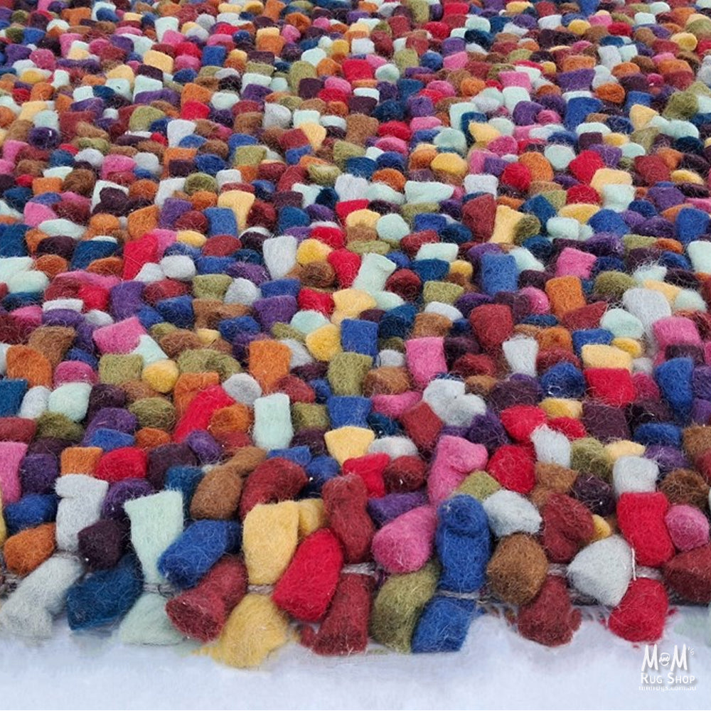 Colorful jelly bean-shaped wool and cotton multicolored toy from India, showcasing soft, vibrant textures and playful design.