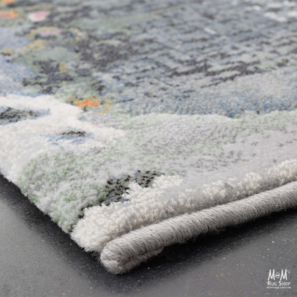 Belgium Kensington Poppy heat set polypropylene rug with vibrant floral pattern and soft texture.