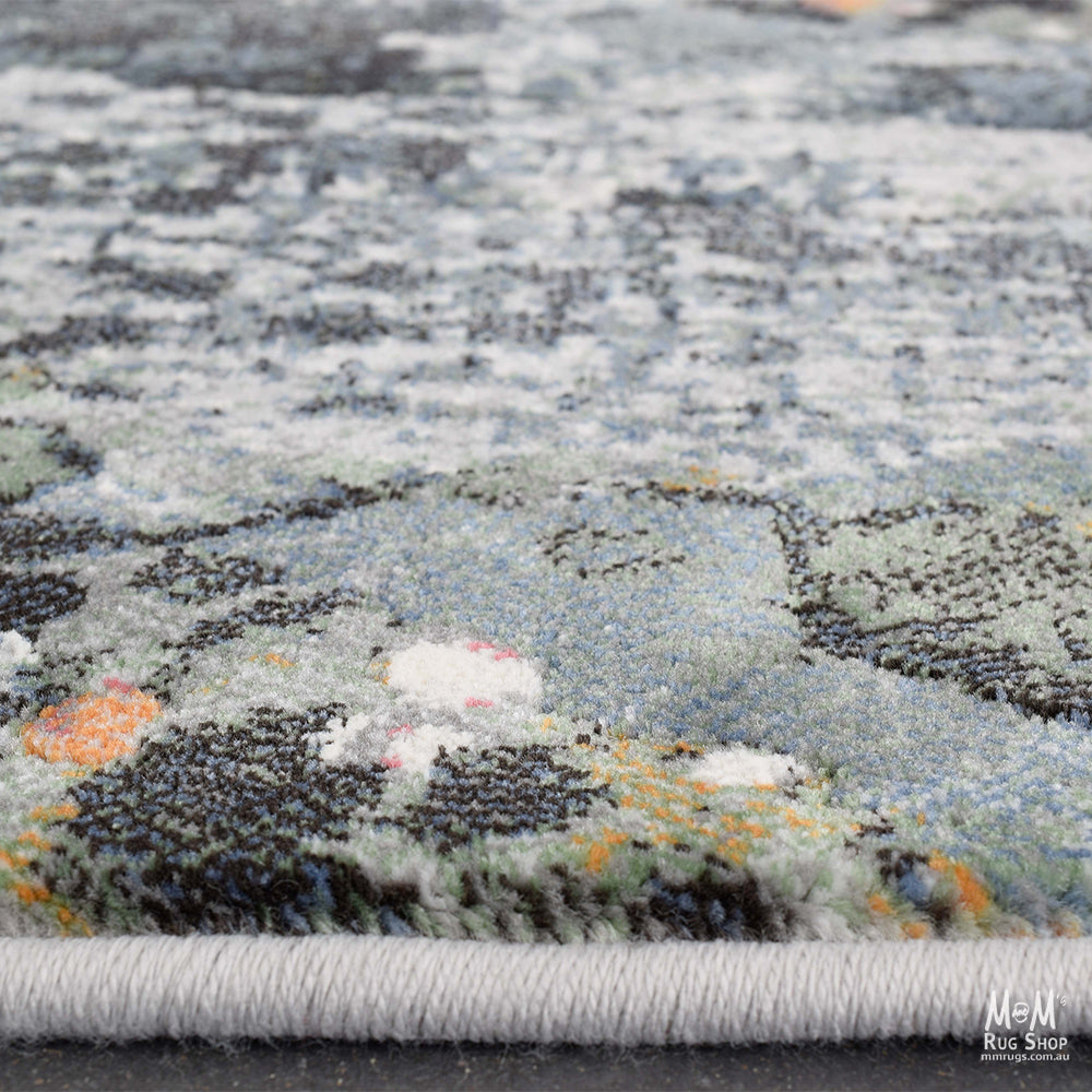 Belgium Kensington Poppy heat set polypropylene rug with vibrant floral design and textured surface.