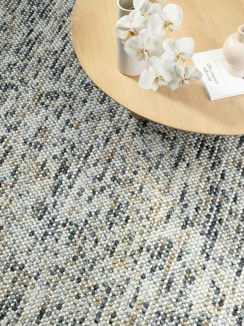 India Magic Mineral wool rug with viscose in grey, mustard, and ochre, shown in detailed insitu view highlighting texture and color blend.