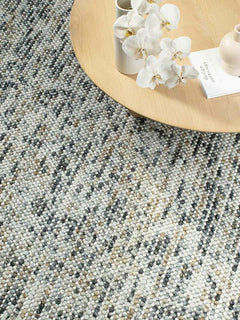 India Magic Mineral wool rug with viscose in grey, mustard, and ochre, shown in detailed insitu view highlighting texture and color blend.