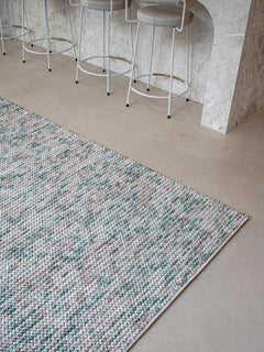 Close-up of Magic Oasis wool and viscose rug from India, showcasing intricate patterns and vibrant colors in a stylish interior setting.