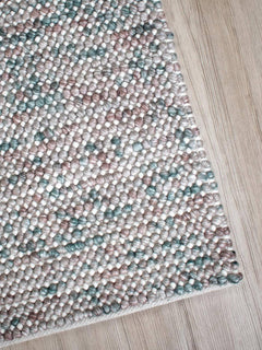 Corner view of the Magic Oasis wool and viscose rug from India, showcasing its intricate patterns and rich textures.
