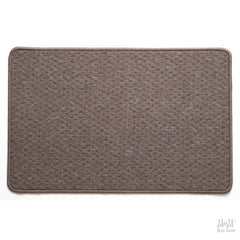 A rectangular, solid taupe colored nylon pile rug with rubber backing.