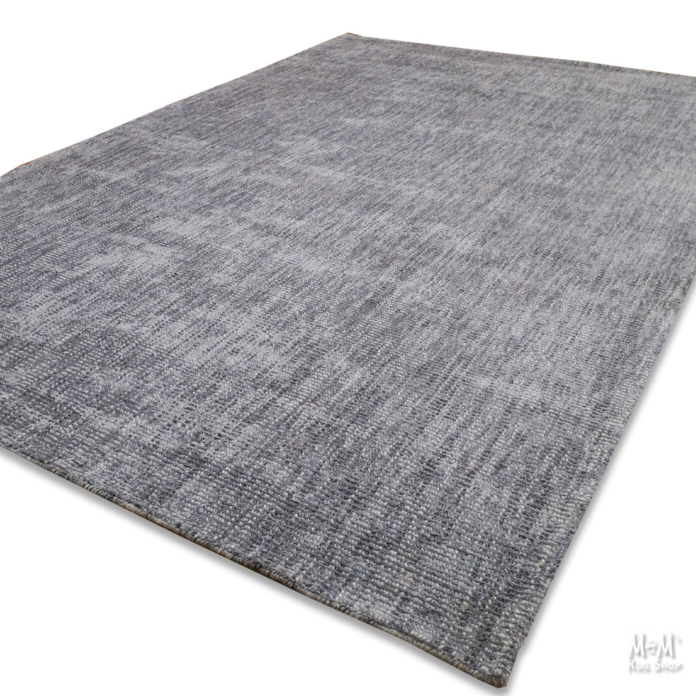Close-up of Toro Slate wool with viscose fabric by India, showing its textured, soft surface and elegant slate color.