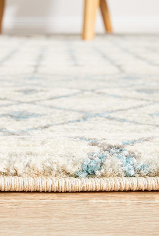 White Evoke Tribal heat set polypropylene rug from Turkey with intricate tribal patterns, showcasing its detailed design and texture.