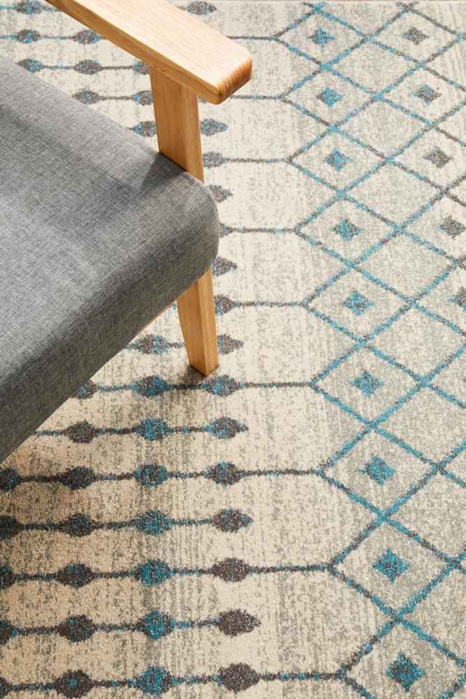 Evoke Tribal White heat set polypropylene flooring by Turkey, showing textured white patterned surface with intricate tribal design.
