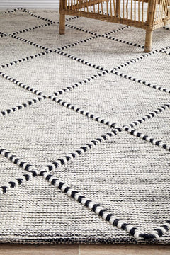 Pure wool Maison Jasmin blanket from India, showcasing soft, woven fabric with intricate patterns in natural tones.