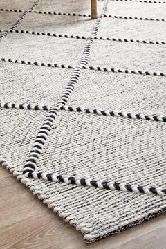 Pure wool Maison Jasmin shawl from India, showcasing intricate woven patterns and soft, high-quality fabric.
