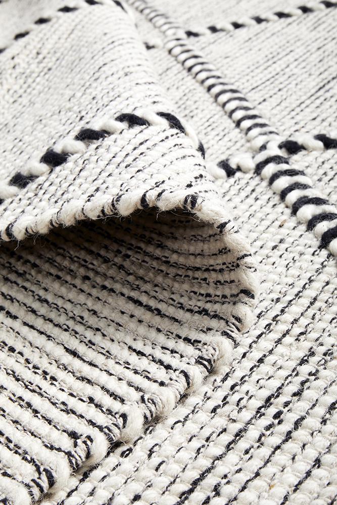 Pure wool Maison Jasmin fabric from India, shown in natural fibers with intricate woven texture and soft, warm appearance.