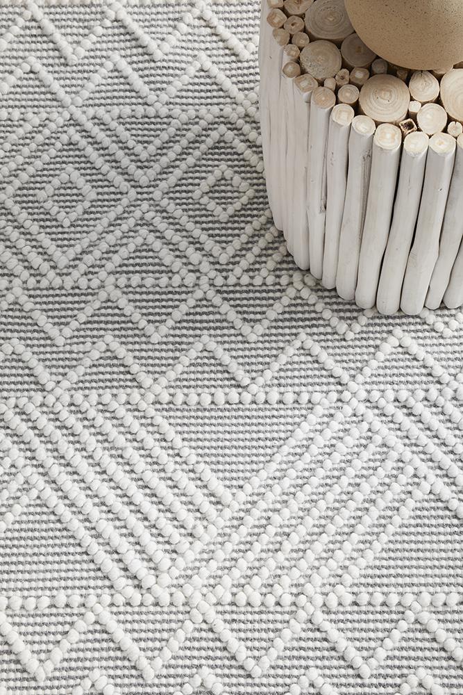 Pure wool Maison Kate sweater by India, shown in a close-up of the textured fabric and classic design.