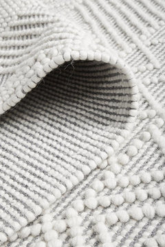 Pure wool Maison Kate sweater by India, featuring a cozy knit texture and classic design, showcased in the image.