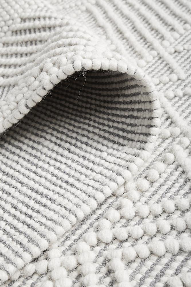 Pure wool Maison Kate sweater by India, featuring a cozy knit texture and classic design, showcased in the image.