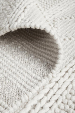 Maison Zoe pure wool sweater by India, featuring a cozy knit design and classic style in neutral tones.