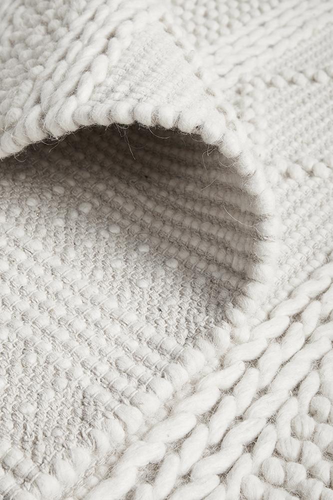 Maison Zoe pure wool sweater by India, featuring a cozy knit design and classic style in neutral tones.
