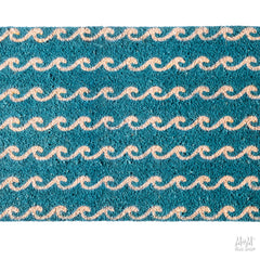 Blue waves PVC coir doormat from M and M's Rug Shop, showcasing textured surface and vibrant wave design.