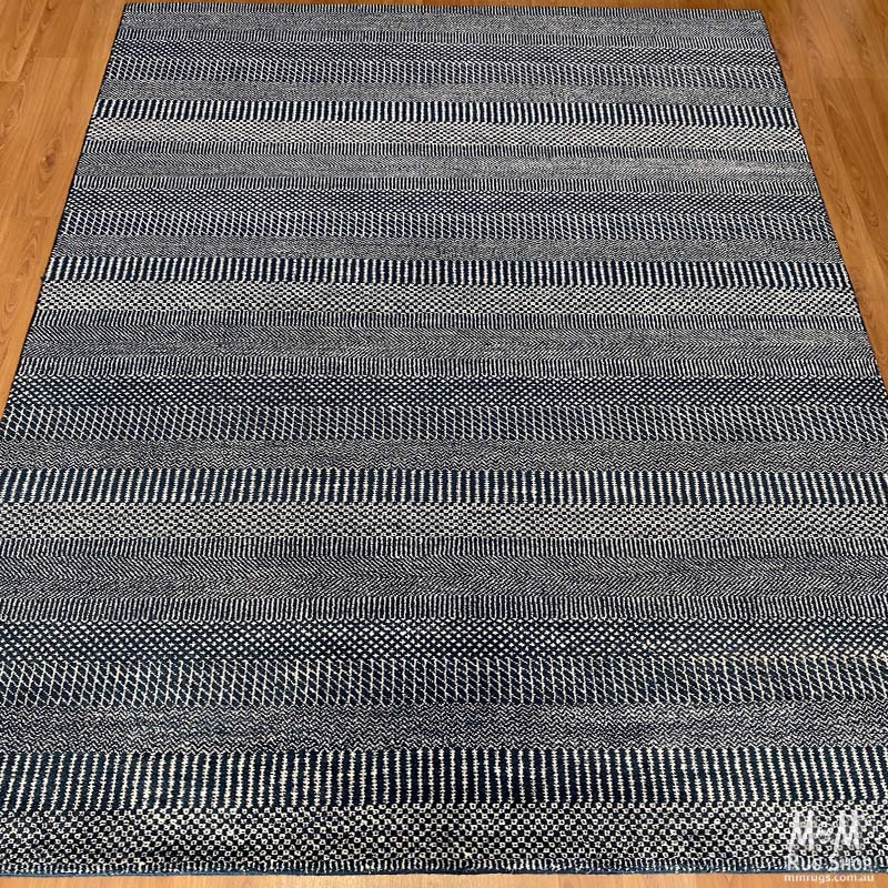 Hamilton deep dark blue pure wool rug by India, showcasing a plush, richly colored textile with intricate texture and design.