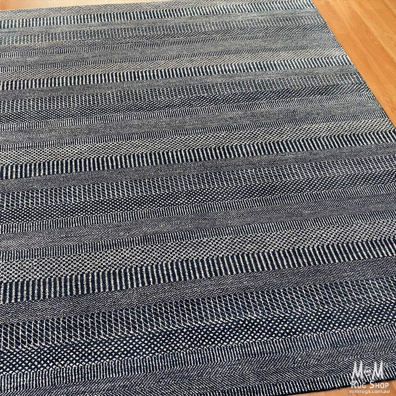 Hamilton Deep Dark Blue pure wool rug by India, showcasing deep blue color and intricate woven pattern on soft wool fabric.