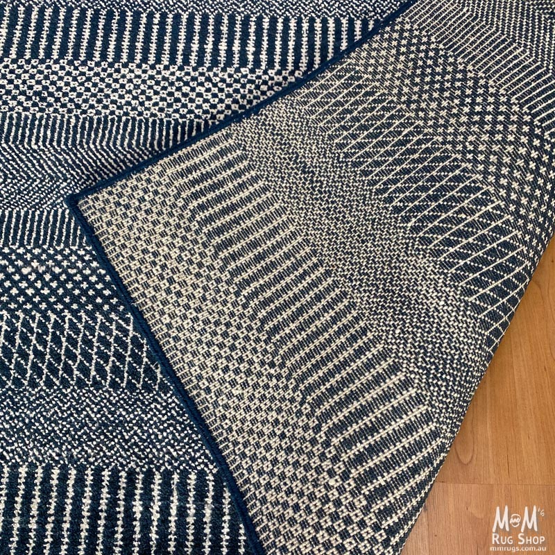 Hamilton deep dark blue pure wool rug from India, showcasing a plush, textured surface with intricate patterns in rich blue tones.