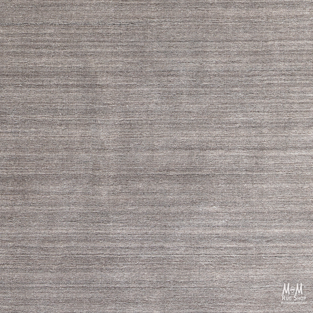 Wool and linen Latitude Plateau rug by India featuring a textured, earthy design with neutral tones and intricate patterns.