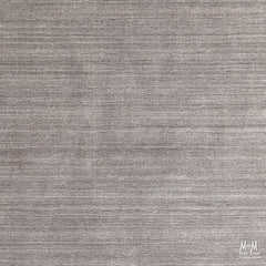 Wool and linen Latitude Plateau rug by India featuring a textured, earthy design with neutral tones and intricate patterns.