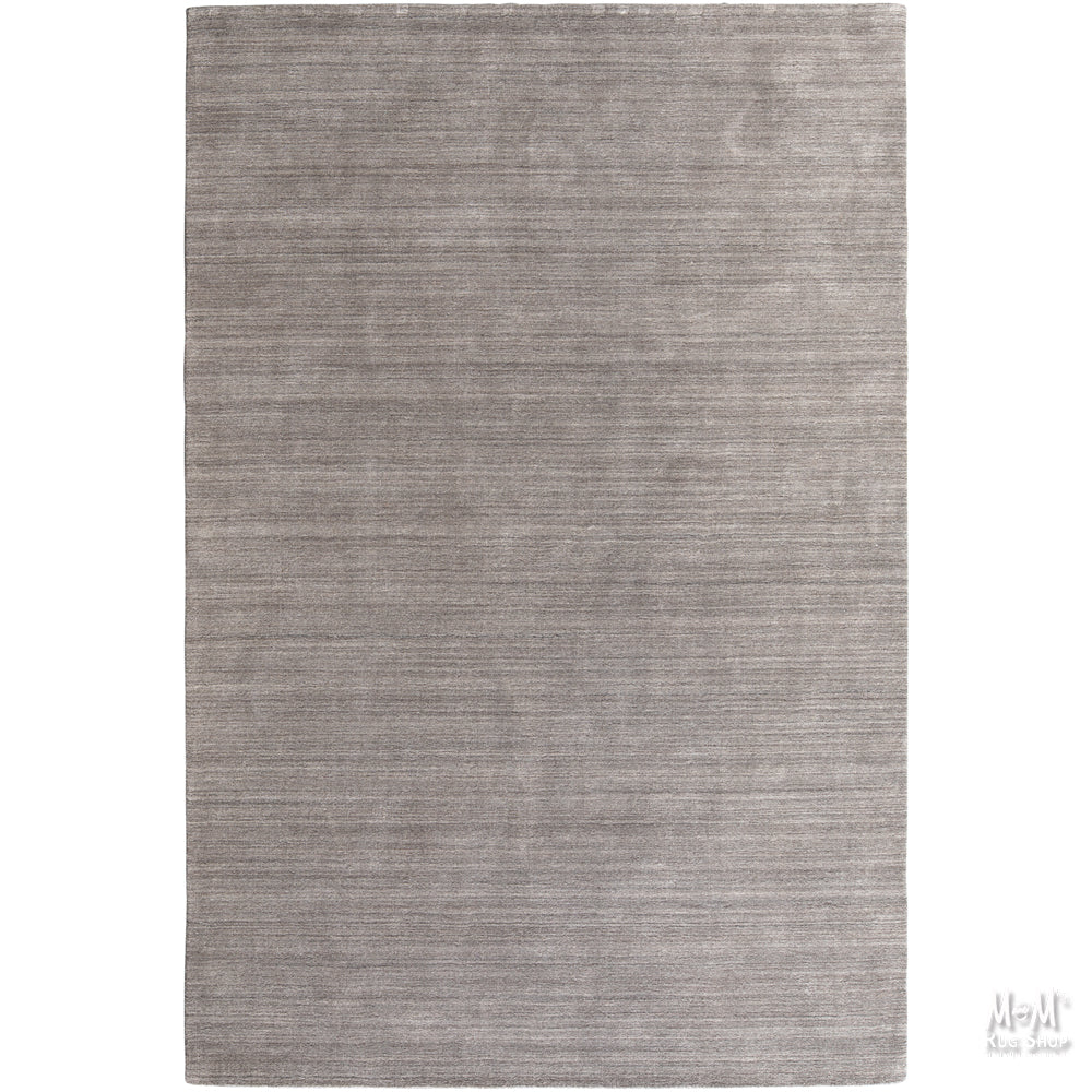Wool and linen Latitude Plateau rug with geometric pattern, crafted by India, displayed on a neutral background.