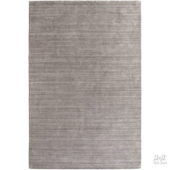 Wool and linen Latitude Plateau rug with geometric pattern, crafted by India, displayed on a neutral background.
