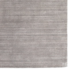 Wool and linen Latitude Plateau rug with intricate patterns, crafted by India, displayed on a neutral background.