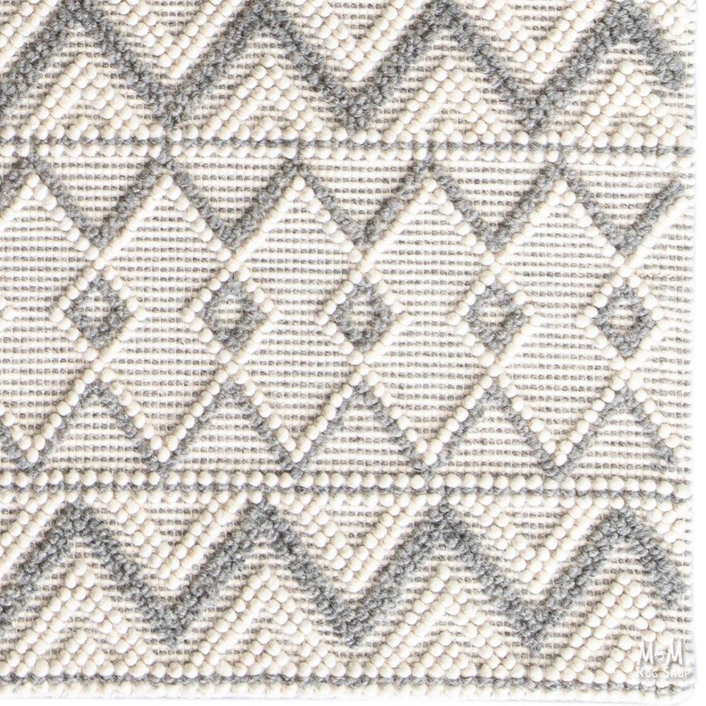 India Memphis Maya pure wool rug with intricate geometric patterns in earthy tones, showcasing soft texture and detailed craftsmanship.