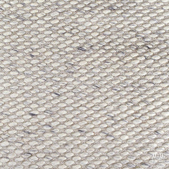 Beige Palmas Pure Wool Rug by India, showcasing a soft, textured wool surface with intricate patterns in a natural beige tone.