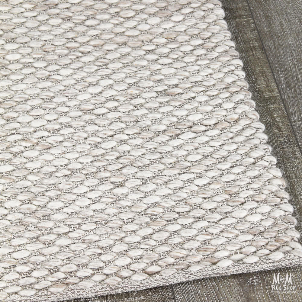 India Palmas Beige pure wool rug with intricate patterns, showcasing its soft texture and elegant design.