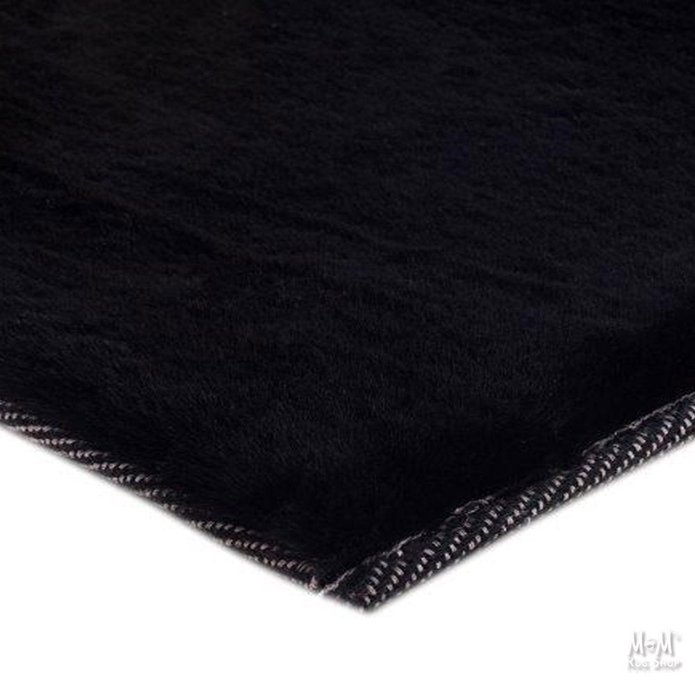 Black Pony rug made from supersoft polyester fabric, featuring a sleek and durable design.