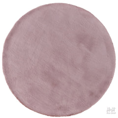 Dusty pink round pony rug made of supersoft polyester, featuring a plush texture and soft, cozy appearance.