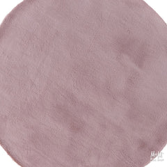 Dusty pink round pony rug made of supersoft polyester, featuring a plush, cozy texture perfect for home decor or children's rooms.