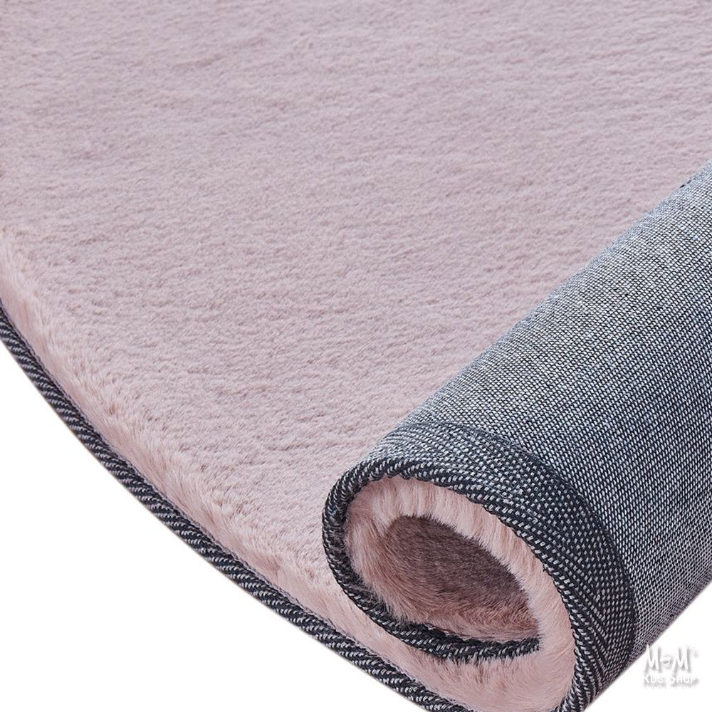Dusty pink round pony rug made of supersoft polyester, featuring a plush, textured surface in a vibrant pink shade.