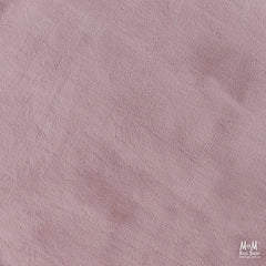 Dusty pink round pony rug made of supersoft polyester, featuring a plush, textured surface with a cozy, inviting appearance.