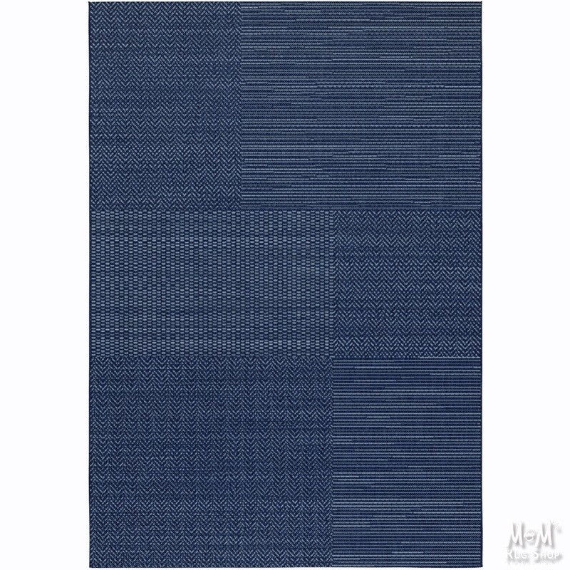 Navy blue polypropylene Prisma Patch rug by Belgium with a textured woven surface and rectangular shape.