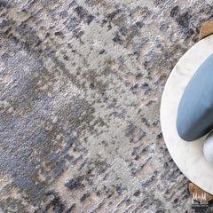 Turkish Raj Taupe polyester pile rug showcasing soft taupe fibers and intricate woven pattern on a neutral background.